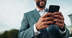 City, smile and closeup of businessman with smartphone for networking, lawyer news or legal chat. Attorney, happy and typing on technology for email, communication or update on law case in low angle