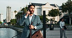 Businessman, walking and city with happiness and phone call for good news with briefcase for work. Male person, entrepreneur and smartphone for communication in Dubai and business conversation.