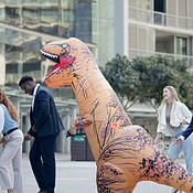 Business, people and dance in costume outdoor with fun inflatable ...