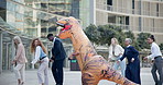 Business, people and dance in costume outdoor with fun inflatable dinosaur and happiness at office. Funny, group and crazy team building performance at work with excited energy or comedy character