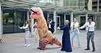 Business, people and dance outdoor in costume of inflatable dinosaur with fun and happiness at office. Funny, group and crazy team building at workplace with excited energy or comedy character