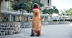Mascot, dance and city with performance, urban office building and documents for work. Costume, inflatable dinosaur and fun for entertainment, company culture and prank with funny business joke