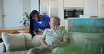 Nurse, senior man and sofa in home with smile, conversation and check with care, kindness and support for wellness. Caregiver, woman and elderly patient on lounge couch, chat and happy in retirement