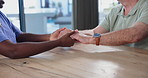 Empathy, senior man and nurse holding hands in a nursing home for assisted living, care or help. Kindness, support and woman volunteer with elderly male for understanding, compassion or assurance