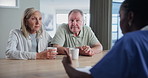 Senior couple, nurse and medical advice with coffee in a hospital for insurance and healthcare. Consulting, support and patient in retirement with communication about cancer diagnosis in a clinic