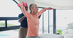 Physiotherapist, senior woman and dumbbells for recovery with care, muscle or wellness at fitness clinic. People, physical therapy and helping hand for rehabilitation, injury and training for arms