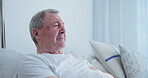 Senior man, sad and home in bedroom with thinking or emotional, crying and retirement with illness. House, bed and pensioner with medical problem or pain and chronic disease on rest or break.