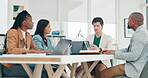 Discussion, team or people with laptop in office for internet, email or planning for business meeting in corporate career. Employees, technology or discussion with diversity in conference room