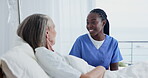 Nurse, discussion and senior woman in hospital bed for support, healthcare and consultation. Medical, caregiver and elderly patient talking for advice, conversation and care for health examination 