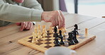 Man, chess and board with hand on knight for challenge, problem solving and competition on table. Thinking, planning and smart elderly person with knowledge for learning, contest and strategy in game