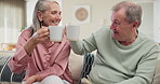 Senior, couple and cheers with drinking  coffee on sofa for bonding, retirement or conversation in living room of home. Elderly people, hot beverage or talking on couch with wellness or morning break
