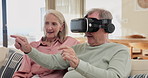 Senior couple, virtual reality and together in home for pointing, click or play 3d metaverse game on internet in living room. Vr, man and woman on sofa with future technology, cyber and conversation