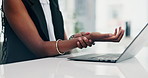 Laptop, wrist pain and business woman in office with injury, accident or medical emergency. Computer, hurt and closeup of African female person with carpal tunnel, fibromyalgia or muscle sprain.