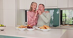 Food, eat and senior couple in kitchen, cook and breakfast in retirement home together. Bonding, love and enjoyment for elderly married people, romance and feeding with snack for nutrition and health