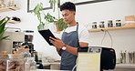 Man, barista and tablet in cafe with order for ecommerce, online sale and service at counter. Male person, waiter and small business with technology for networking, website or digital menu update