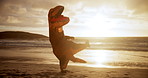Dinosaur costume, funny and kickboxing at beach with fun, and performance and fight in air. Fitness, sunset and inflatable mascot with punch for energy, entertainment and cardio exercise in nature