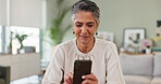 Mature, woman and smartphone in home and happy, technology for search or online streaming. Social media, reading meme or typing in living room with internet chat, laughing in apartment for post