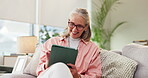 Elderly woman, sofa and relax with tablet for communication, notification or scroll for online media. Senior person, smile and happy with technology for website, research or networking in living room