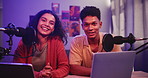 Video, man and woman in live stream with mic, conversation and hosting online radio talk show in home. Interview, broadcast and happy people vlogging with microphone chat, tech and content creation