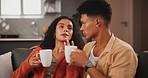 Couple, morning and relax with coffee for chat, conversation or gossip on living room sofa at home. Young man listening to woman talking in discussion or communication with beverage or drink at house
