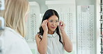 Glasses, store and woman in consultation with optometrist and customer shopping with choice. Check, prescription and person with decision for eyewear, spectacles and lens with frame in retail