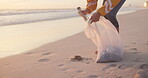 Volunteer, beach and plastic cleaning or pollution in nature or community service, garbage or waste management. Person, climate change and ocean litter pickup as recycle, global warming or future