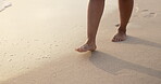 Feet, legs and walking on beach sand with ocean, travel and vacation on tropical island for peace and calm. Footprint, journey and adventure outdoor, waves and sea shore with tourism for summer