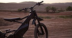 Nature, electric bike and transportation in desert for sports, challenge or cycling for training or biking. Travel, future or mobile vehicle for outdoor competition and eco friendly on background