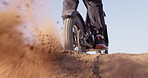 Sport, motorcycle and sand in wheel from desert driving and person with off road stunt on hill. Dirt, trail and fast driver travel on motorbike with skill, technique and moto adventure in countryside