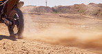 Bike, sand and wheels with sports person on off road course for competition, performance or race. Motorcycle, training and tyres with athlete rider on vehicle for adventure, adrenaline or power