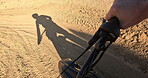 POV, hands and off road motorbike with person on dirt track for adrenaline, adventure or speed closeup. Bike, sports and training with athlete rider on sand course for action, performance or race