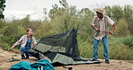 Camping, couple and pitch tent in nature on holiday, vacation and interracial people travel outdoor. Campsite, man and woman setup together, conversation and help with preparation in the countryside