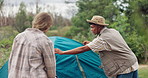 Camping, couple and pitch tent for travel on holiday, vacation and interracial people in nature outdoor. Campsite, man and woman setup together, talking and help with preparation in the countryside