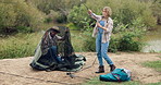 Man, woman and tent or setting up in forest for camp site, wilderness and nature and relaxation. Couple, pitching or funny or stuck for dumb in park, woods or recreation with trees for adventure