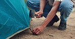 Hands, hammer and tent to prepare for camping with building, survival or vacation in nature. Person, tools and mallet for shelter, safety and ready with protection from cold on holiday in countryside