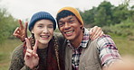 Selfie, camping and couple hug with peace, hands or tongue out in forest with love, care or adventure in nature. Portrait, profile picture or people embrace in a jungle for travel, hiking or memory