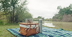 Lake, coffee and camping picnic with bottle in woods with date, morning and travel outdoor. Nature, food and holiday with tea for breakfast by the water for adventure with drink and blanket in forest
