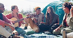 Friends, campsite and guitar for singing in nature with music, relax and together on vacation in countryside. Men, women and people with song by tent for art, holiday or performance in bush at picnic