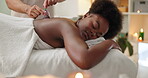 Woman, cupping therapy and back pain treatment or relax for blood flow benefits, drainage or inflammation. Black person, massage therapist and hands with circulation, pressure points or self care