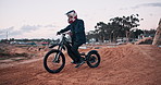 Man, bike and outdoor for race, adventure or action on sand at cycling rally in Dubai. Electric bicycle, professional rider and person on dirt road for extreme sports, fast and speed for training