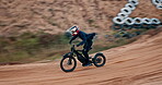 Man, bike and off road for race, adventure or action on sand at cycling rally in Dubai. Electric bicycle, professional rider and person on dirt for extreme sports, fast and speed for jump outdoor