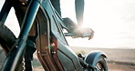 Biker, motorbike and person with chair in outdoor training and safety for extreme sports and practice on sand. Chair, hands and driver with gear for dunes, race or cycling in challenge on holiday