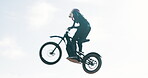 Biker, motorbike and man in air or outdoor training for extreme sports, safety and practice on sand. Sky, off road or fearless driver jumping with motorcycle trick for race or cycling in challenge