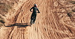 Outdoor, motorbike and man with training, sand or safety with extreme sports or challenge with energy. Dune, sunshine or driver with protection or travel with cycling, balance or adventure with speed
