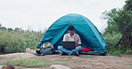 Man, camping and remote work with laptop in nature for planning, research or or internet solution. Freelance, tent and off grid digital nomad in forest for pc, search or travel blog content creation