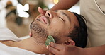 Man, gua sha and face treatment in spa with massage for chronic pain, pressure points or lymphatic drainage. Male person, beautician and hands as jade tool or circulation benefits, skincare or beauty