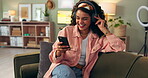 Woman, headphone and signing on sofa, cellphone and karaoke for fun and entertainment in home. Audio, music and technology with dance for radio and smartphone, happy and female person in living room