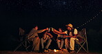 Camping, cheers and night with friends by fire outdoor in nature for adventure, bonding or getaway together. Travel, toast and dark with group of happy young people drinking on holiday or vacation