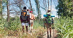 Backpack, hiking and friends walk in nature to explore on adventure, journey and trekking in forest. Fitness, travel and men and women in woods on holiday, vacation and weekend for camping outdoors