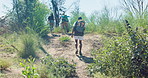 Travel, hiking and friends in nature walk to explore on adventure, journey and trekking in forest. Fitness, backpacking and men and women in woods, nature and outdoors on holiday, vacation or weekend